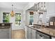 A well-equipped kitchen featuring stainless steel appliances, granite countertops, and stylish white cabinetry at 405 Emerson Dr., Myrtle Beach, SC 29579