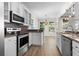 Kitchen boasts stainless appliances, granite counters and pass through to a dining space, offering both style and function at 405 Emerson Dr., Myrtle Beach, SC 29579
