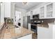A well-equipped kitchen featuring stainless steel appliances, granite countertops, and stylish white cabinetry at 405 Emerson Dr., Myrtle Beach, SC 29579