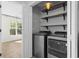 Convenient laundry room featuring front loading washer and dryer and built-in shelving at 405 Emerson Dr., Myrtle Beach, SC 29579