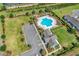 Aerial view of the community pool, playground, parking, and clubhouse on a sunny day at 4061 Taranto Loop # A, Myrtle Beach, SC 29579