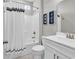 Bright bathroom with a shower featuring black striped curtains and a white vanity at 4061 Taranto Loop # A, Myrtle Beach, SC 29579