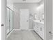 Modern bathroom with a tiled floor, glass shower enclosure, and white cabinets at 4061 Taranto Loop # A, Myrtle Beach, SC 29579
