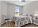 Cozy bedroom featuring a floral-patterned bedspread, wood floors, and a bright window at 4061 Taranto Loop # A, Myrtle Beach, SC 29579