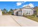 Home exterior featuring a wide driveway and attached garage, set in a well-maintained community at 4061 Taranto Loop # A, Myrtle Beach, SC 29579