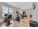 Well-lit gym featuring modern exercise equipment, windows, and wood-look floors for a complete workout experience at 4061 Taranto Loop # A, Myrtle Beach, SC 29579