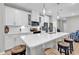 Bright kitchen features an island with barstool seating, stainless appliances, and white cabinetry at 4061 Taranto Loop # A, Myrtle Beach, SC 29579