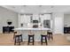 Open kitchen with white cabinets, stainless appliances, island with seating and pendant lights at 4061 Taranto Loop # A, Myrtle Beach, SC 29579