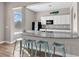 Charming kitchen features granite counters, modern appliances, bar seating, and wood-look flooring at 4061 Taranto Loop # A, Myrtle Beach, SC 29579