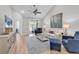 Open-concept living room with modern furniture, wood flooring, and natural light at 4061 Taranto Loop # A, Myrtle Beach, SC 29579
