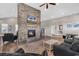 Bright living room boasts a striking stone fireplace, TV, and modern furniture on stylish wood-look floors at 4061 Taranto Loop # A, Myrtle Beach, SC 29579