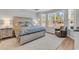 Serene main bedroom featuring a king bed, sitting area, and ample natural light from large windows at 4061 Taranto Loop # A, Myrtle Beach, SC 29579
