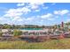 Community swimming pool surrounded by lounge chairs, umbrellas, and lush landscaping on a sunny day at 4061 Taranto Loop # A, Myrtle Beach, SC 29579