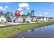 Charming street view of residential homes with attached garages and a nearby pond at 4061 Taranto Loop # A, Myrtle Beach, SC 29579