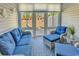 Cozy sunroom features stylish blue and white furniture and serene views of the backyard at 4061 Taranto Loop # A, Myrtle Beach, SC 29579