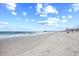 A serene beach scene with gentle waves, clear skies, and a distant pier for scenic views at 410 N Waccamaw Dr. # 306, Murrells Inlet, SC 29576