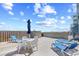 A spacious deck with a table, chairs, loungers, and beach views provides relaxation at 410 N Waccamaw Dr. # 306, Murrells Inlet, SC 29576