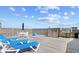 Spacious wooden deck featuring beach access stairs, an outdoor shower, and lounge chairs at 410 N Waccamaw Dr. # 306, Murrells Inlet, SC 29576