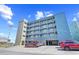 Beautiful light-blue condominium building with a parking garage and the 