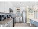 Bright kitchen features stainless steel appliances, granite countertops, and a stylish blue glass backsplash at 410 N Waccamaw Dr. # 306, Murrells Inlet, SC 29576