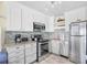 Modern kitchen featuring stainless steel appliances, granite countertops, and white cabinetry at 410 N Waccamaw Dr. # 306, Murrells Inlet, SC 29576