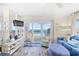 Charming living room with stylish furniture, a TV, and a stunning ocean view from the balcony at 410 N Waccamaw Dr. # 306, Murrells Inlet, SC 29576