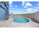 Outdoor pool with varying depths, surrounded by a concrete patio and a protective fence at 410 N Waccamaw Dr. # 306, Murrells Inlet, SC 29576
