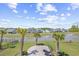 Beautiful backyard with a pond, palm trees, and ample space for outdoor enjoyment at 422 Harbour View Dr., Myrtle Beach, SC 29579