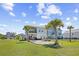Expansive backyard showcasing a patio with hammocks, lush lawn, and two-story homes at 422 Harbour View Dr., Myrtle Beach, SC 29579