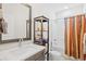 Clean bathroom with a shower-tub combo, wooden shelves, and a well-lit vanity at 422 Harbour View Dr., Myrtle Beach, SC 29579