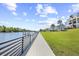 Scenic boardwalk view of waterfront homes and lush greenery, with palm trees lining the path at 422 Harbour View Dr., Myrtle Beach, SC 29579