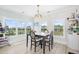 Bright dining area featuring large windows with backyard views, an elegant chandelier, and modern décor at 422 Harbour View Dr., Myrtle Beach, SC 29579