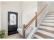 Bright entryway with wood stairs, a decorative front door, and a custom bench with storage at 422 Harbour View Dr., Myrtle Beach, SC 29579