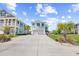 Charming, light blue two-story home with an attached two-car garage and a concrete driveway at 422 Harbour View Dr., Myrtle Beach, SC 29579