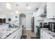 Modern kitchen with stainless steel appliances, granite countertops, and sleek white cabinetry at 422 Harbour View Dr., Myrtle Beach, SC 29579