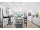 Spacious kitchen with modern appliances, marble counters, an island bar, and a view into the living room at 422 Harbour View Dr., Myrtle Beach, SC 29579
