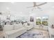 Open concept living room shows the kitchen, dining area, and white sofas under a ceiling fan at 422 Harbour View Dr., Myrtle Beach, SC 29579