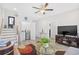 Open living room with stairs, TV, mini fridge, wood floors, and a glass coffee table at 422 Harbour View Dr., Myrtle Beach, SC 29579