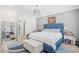The main bedroom has a blue bed frame, light colored walls, a ceiling fan and wood flooring at 422 Harbour View Dr., Myrtle Beach, SC 29579