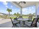 Charming patio with a ceiling fan, outdoor seating, and a view of the serene backyard pond at 422 Harbour View Dr., Myrtle Beach, SC 29579