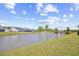 Scenic pond view featuring a fountain, lush greenery, and neighboring homes in the distance at 422 Harbour View Dr., Myrtle Beach, SC 29579