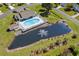 Aerial shot featuring a beautiful backyard pool, pond, and lush landscape at 466 Wampee St. Nw, Calabash, NC 28467