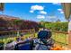 Cozy back deck featuring a grill, seating, and lush greenery for outdoor enjoyment at 466 Wampee St. Nw, Calabash, NC 28467