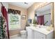 Well-lit bathroom featuring a window, vanity, and classic fixtures at 466 Wampee St. Nw, Calabash, NC 28467