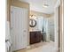 Well-lit bathroom featuring modern fixtures, marble floors, vanity with stylish mirror and glass shower at 466 Wampee St. Nw, Calabash, NC 28467