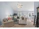 Open-concept living room with neutral paint, vaulted ceiling, and seamless flow to the dining area at 466 Wampee St. Nw, Calabash, NC 28467