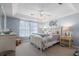 Comfortable bedroom with tray ceiling, ceiling fan, soft lighting, and neutral decor at 466 Wampee St. Nw, Calabash, NC 28467