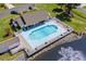 Aerial view of backyard pool with a deck, seating, and views of a pond at 466 Wampee St. Nw, Calabash, NC 28467