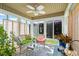 Bright and airy sunroom with ample windows, comfortable seating, ceiling fan, and cozy decor at 466 Wampee St. Nw, Calabash, NC 28467