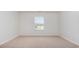 Bright and airy empty room featuring neutral carpeting and a window with natural light at 500 Scarlet Sage Dr., Conway, SC 29527